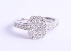 An 18ct diamond set ring, pave set with six princess cut diamonds within a border of thirteen