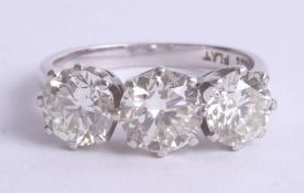 A fine diamond three stone ring, set in 18ct white gold, combined diamond weight approximately 3.