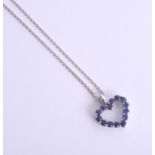 An 18ct white gold heart-shaped pendant, set with blue stone (sapphire?) on a fine chain.