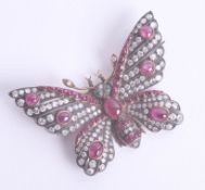 An impressive antique ruby, diamond and emerald butterfly brooch, approx. 53mm wing span set in