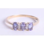 A 14ct diamond and tanzanite ring, size R.