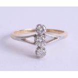 An 18ct gold and platinum three stone diamond ring, each diamond approx 3mm diameter, size N.