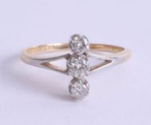 An 18ct gold and platinum three stone diamond ring, each diamond approx 3mm diameter, size N.