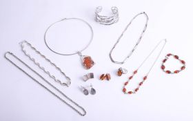 A collection of modern silver and amber set contemporary jewellery, including bangles, necklace,