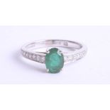 An 18ct white gold, emerald and diamond set ring, size K.