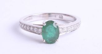 An 18ct white gold, emerald and diamond set ring, size K.