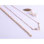 A 14k pearl and diamond pendant with matching bracelet and earrings (with US purchase