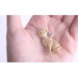 An 18ct gold cat brooch with emerald eyes and a diamond bow approx. 35 x 22mm, 21.40g.