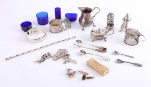 A small silver cream jug, silver mustard pots, charm bracelet, gilt cufflinks, gilt lighter and