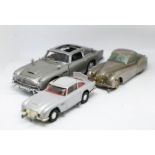 Three models, Kolner Jaguar German, Recent Corgi 007 Aston Martin DB5, with another Aston Martin