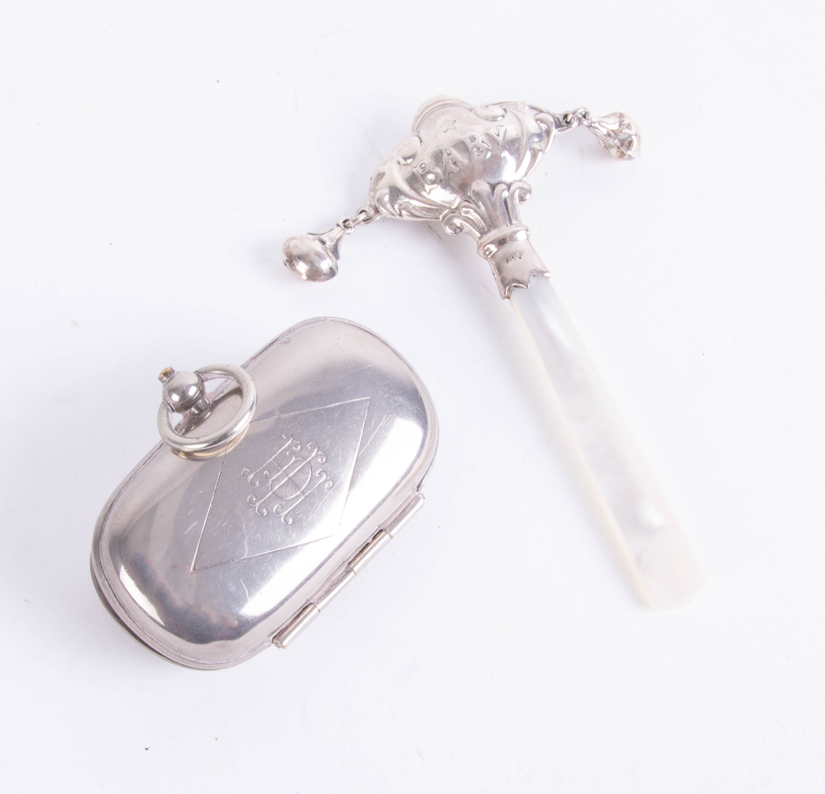 A silver baby rattle with Mother of Pearl handle together with a Sovereign holder (2).