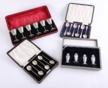 Two silver spoon sets, cased, together with a six piece miniature goblet set, the case marked The