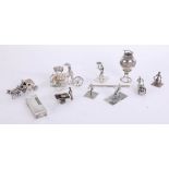 A collection on miniature silver objects including figures with wheeled barrows, horse and coach,