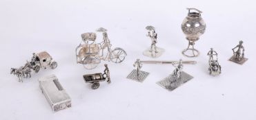 A collection on miniature silver objects including figures with wheeled barrows, horse and coach,