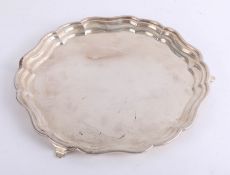 A silver salver with gadrooned border on three feet, diameter 30cm, weight approx. 20oz.