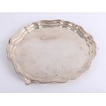 A silver salver with gadrooned border on three feet, diameter 30cm, weight approx. 20oz.