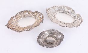 A pair of pierced silver ornate bonbon dishes, hallmarked, length 17cm and another smaller dish (