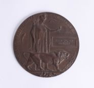 A Great War bronze 'death plaque' awarded to Phillip Sydney Peacock with card envelope.