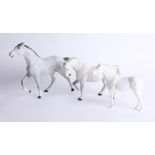 Beswick, a dapple grey racehorse, unglazed, a glazed white horse and cohort, unglazed white, tallest