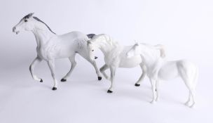 Beswick, a dapple grey racehorse, unglazed, a glazed white horse and cohort, unglazed white, tallest