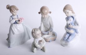A collection of four Nao figures including 'Girl with flowers'.