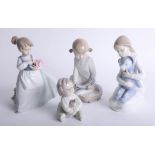 A collection of four Nao figures including 'Girl with flowers'.