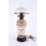 A Victorian oil lamp with opaline shade, damaged, height 60cm.