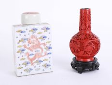 An oriental porcelain tea caddy, height 16cm, together with a reproduction cinnabar vase (2).