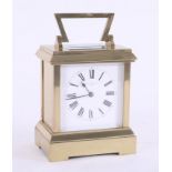 A brass carriage clock with striking movement, marked Howell James & Co, London, height 20cm with