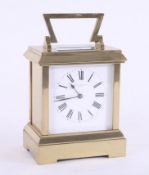 A brass carriage clock with striking movement, marked Howell James & Co, London, height 20cm with