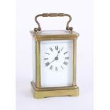 A carriage clock, brass case, Roman numerals, with key, height 14cm, handle up.