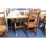 Heals, an oak refectory dining table and six bar back chairs with woven seats.