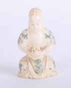 An oriental carved ivory seated figure, height 7cm.