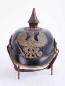 A WWI German Prussian Pickelhaube, the badge marked 'FR Koenig' with chin strap.