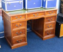 A mahogany pedestal desk, fitted with nine drawers, with a green leather top, 122cm x 61cm.