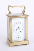 A French carriage clock with alarm, with Roman numerals, two dials, height 15cm, handle up.