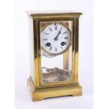 A brass four glass clock with pendulum and key, overal height 22cm.