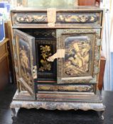 A late 19th/early 20th century Chinese lacquered cabinet on stand, the interior fitted with an