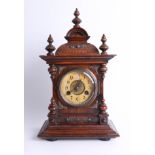 A Victorian walnut mantle clock with striking gong, with key, height 43cm.