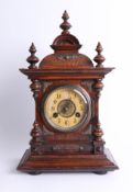 A Victorian walnut mantle clock with striking gong, with key, height 43cm.