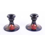 Two Moorcroft pomegranate candlesticks.