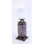 Royal Doulton, an art pottery oil lamp, damaged, with opaline shade, height including shade 52cm.