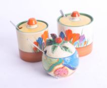 Clarice Cliff, condiment pots including two Crocus and one Fantasque (3).