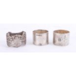 A pair of Geo V Chester silver napkin rings and a Pearce and Sons silver napkin ring (3),4.75 oz.