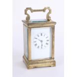 A carriage clock, brass case, striking on a gong, Roman numerals, with key, height 17cm handle up.