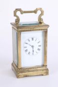 A carriage clock, brass case, striking on a gong, Roman numerals, with key, height 17cm handle up.