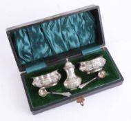 A Victorian silver salt and pepper set, with two spoons, cased. (5)