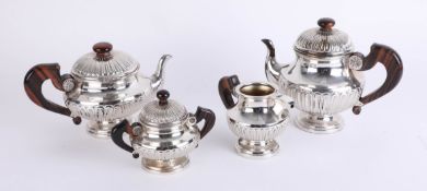 Silver? A four piece continental tea service, unmarked, with faux rosewood handle and finial,