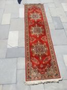 A patterned floor runner, 0.81m x 2.91m.