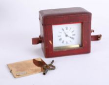 A carriage clock of squat form, with travel case, the dial marked J.C. Vicary of London, with key,